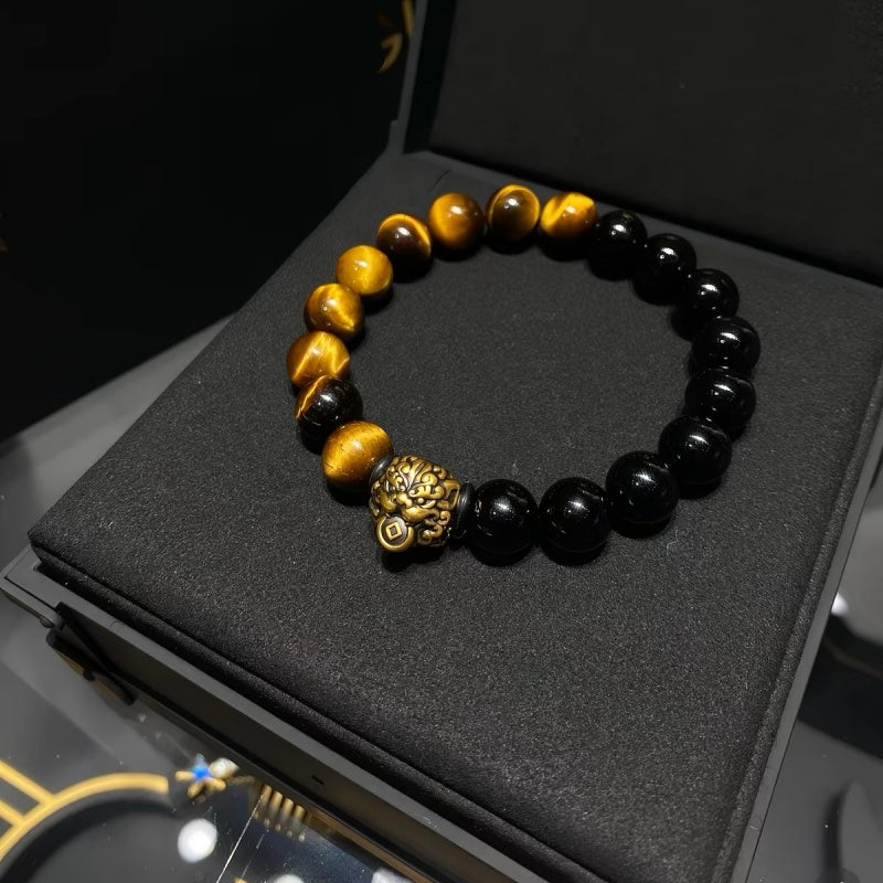 Tiger Eye and Black Onyx bracelet held in hand with gift box