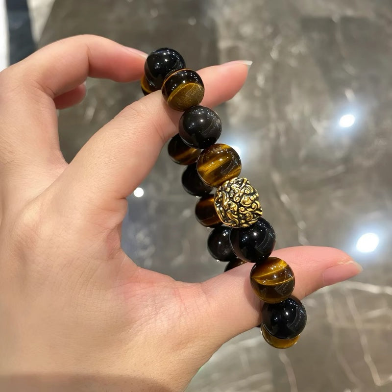 Tiger Eye bracelet with Pixiu charm on hand