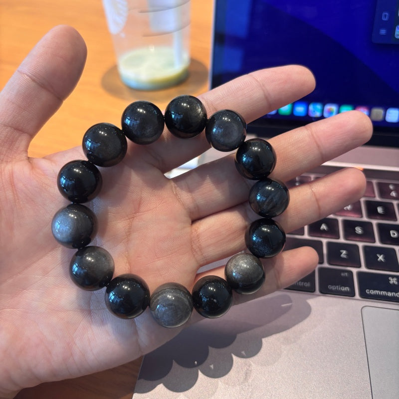 16mm Black Obsidian bracelet held in palm