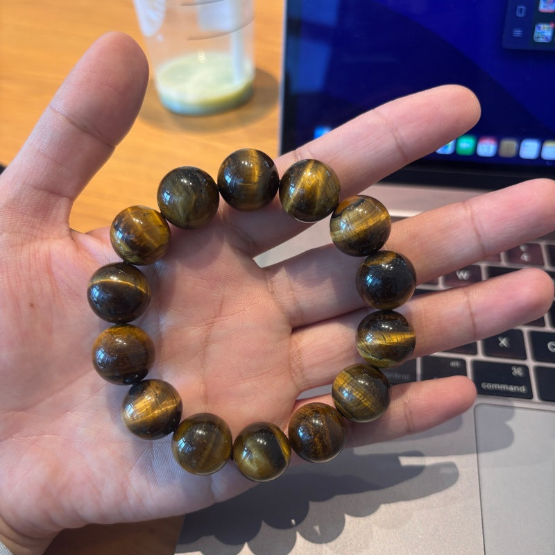 16mm Tiger Eye bracelet held in palm