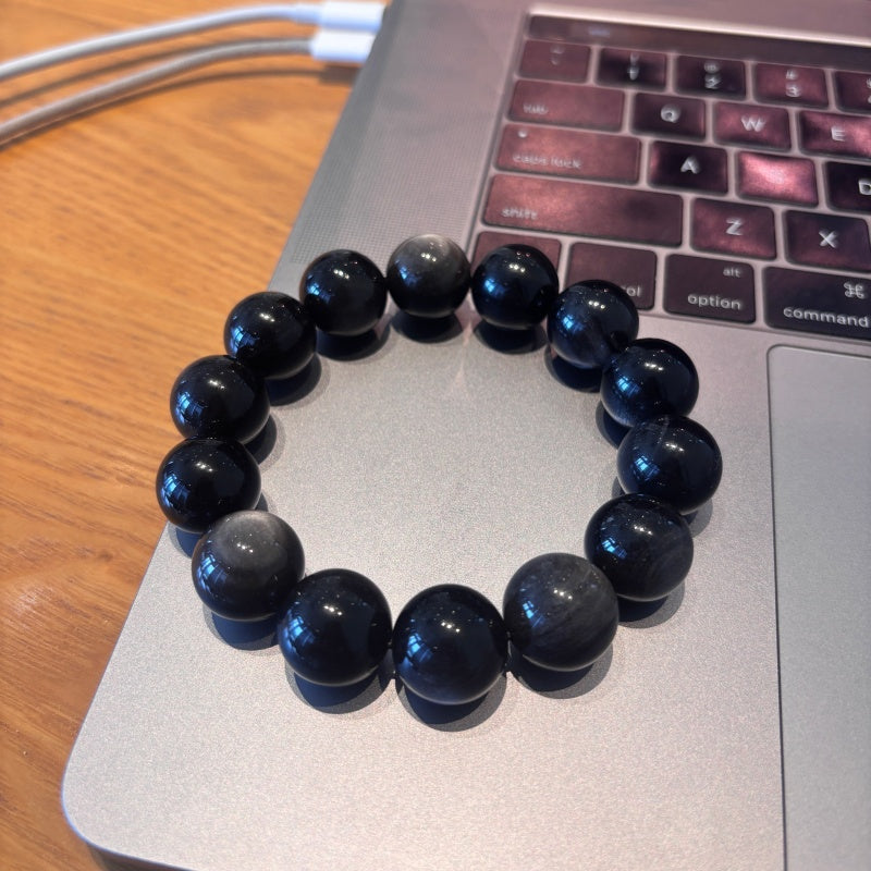 16mm Black Obsidian bracelet on laptop keyboard