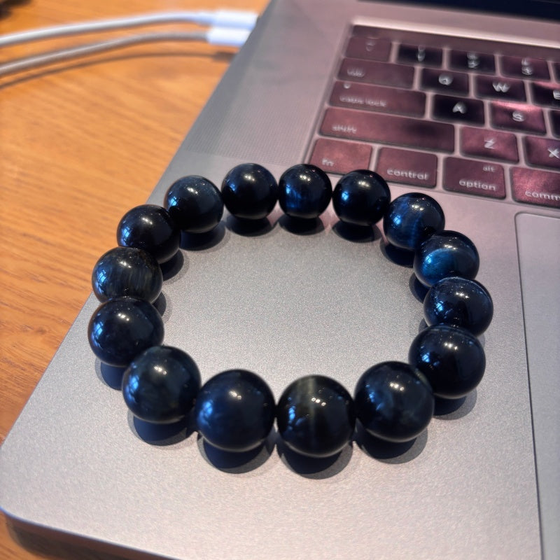 14mm Blue Tiger Eye bracelet on laptop keyboard