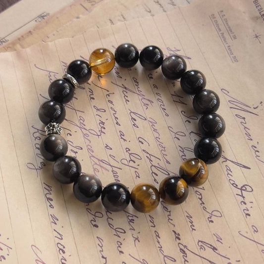 Tiger Eye and Black Obsidian bracelet on vintage letter paper side view