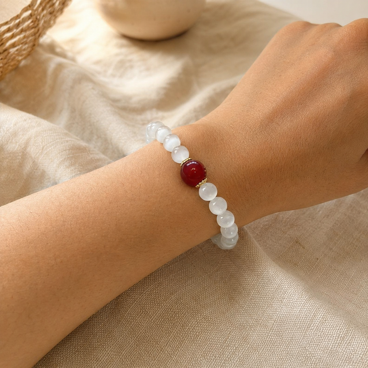 White bead red agate bracelet worn on wrist
