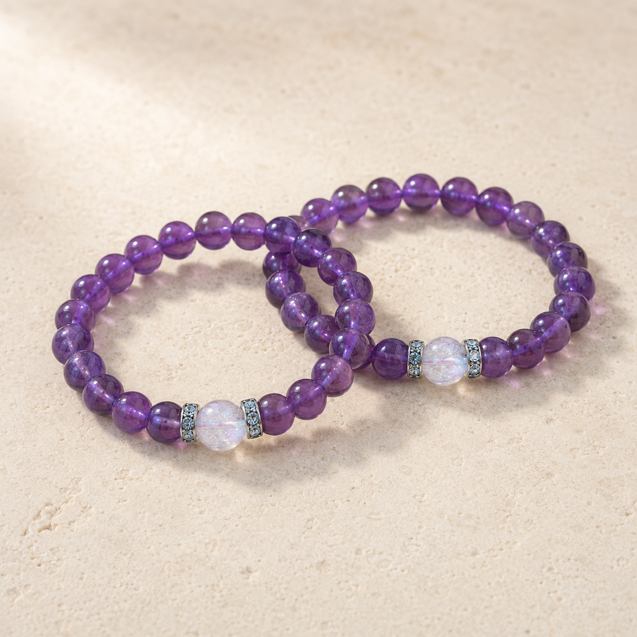 Amethyst and crackle clear quartz bracelet flat lay on stone surface