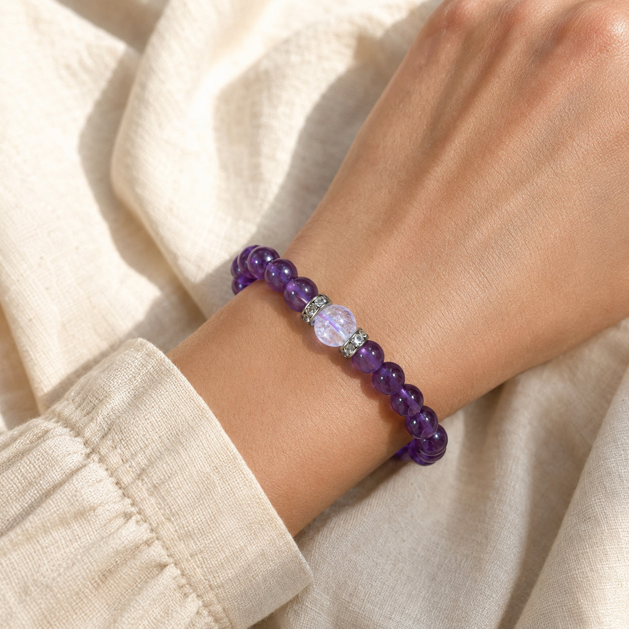 Amethyst manifestation bracelet held in hand
