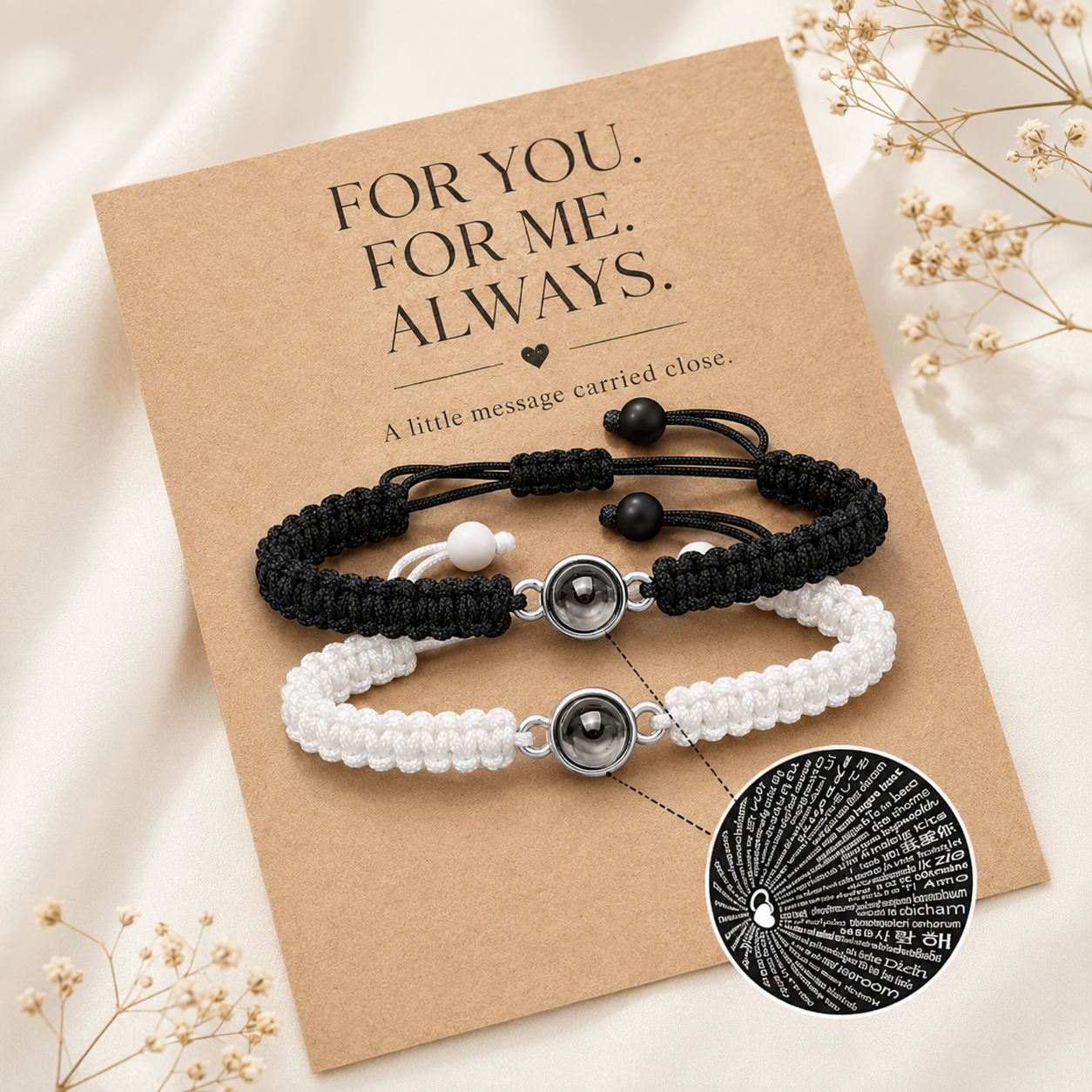 Product detail view of black and white projection bracelets showing braided cord, projection charm, and adjustable beads