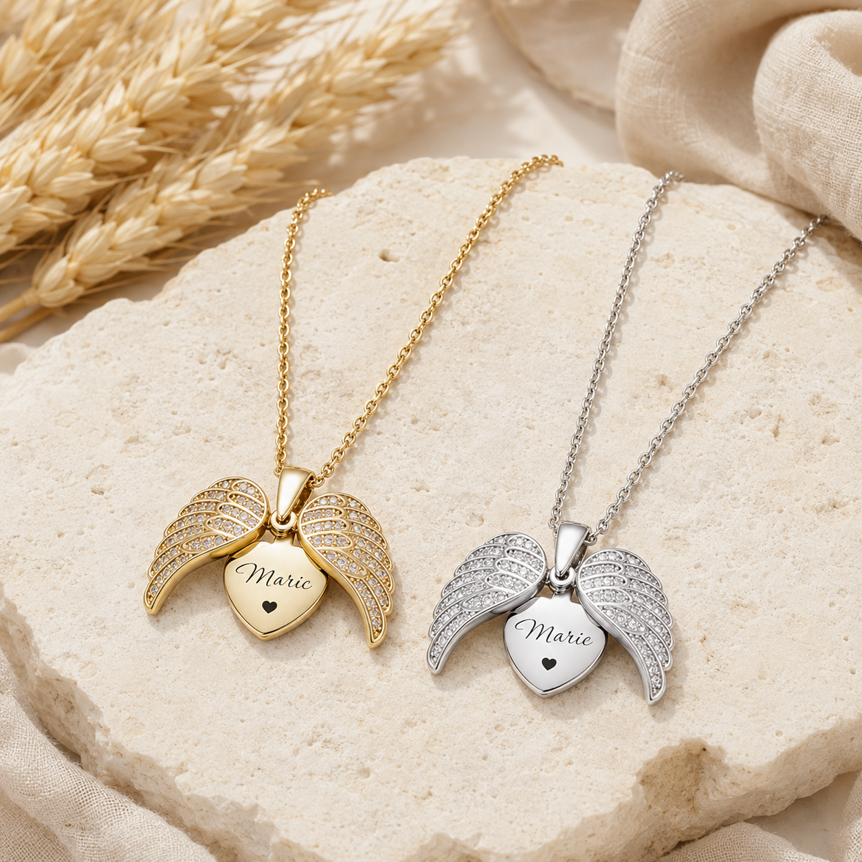 Gold and silver angel wing necklaces on white background