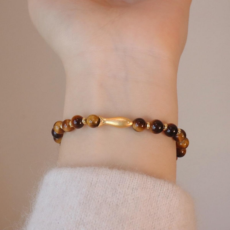 Tiger Eye Gold Fish Bracelet flat lay on paper
