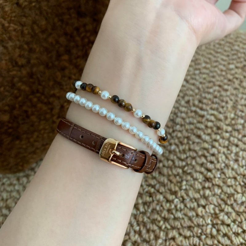4mm Tiger Eye Pearl Bracelet - on wrist with leather bracelet