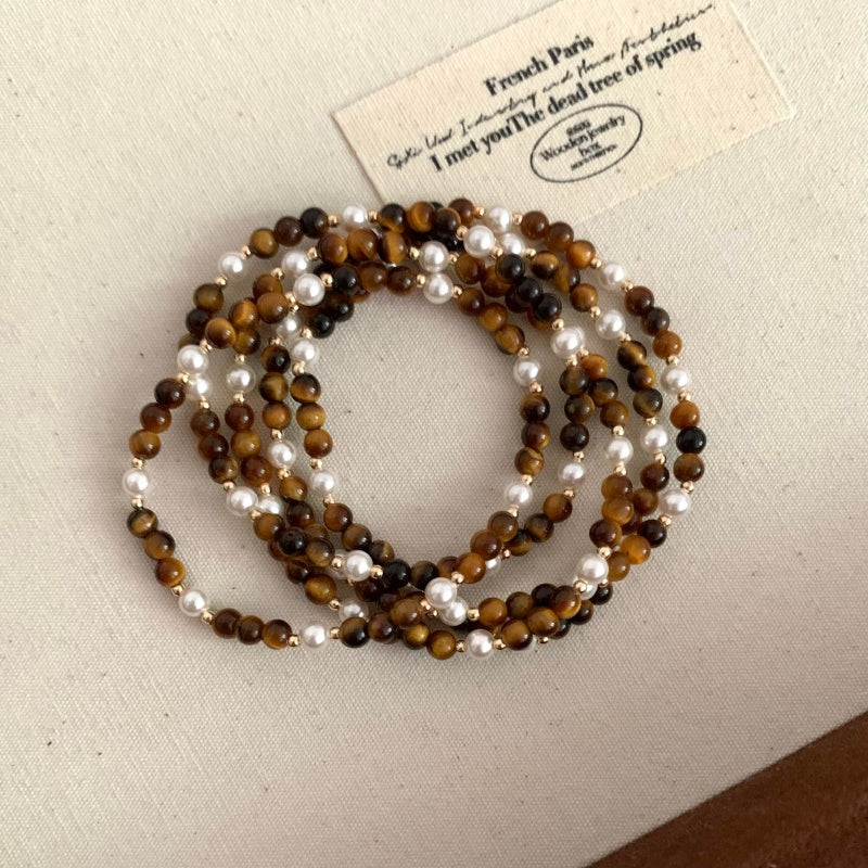 4mm Tiger Eye Pearl Bracelet - on wrist with gold bow bracelet